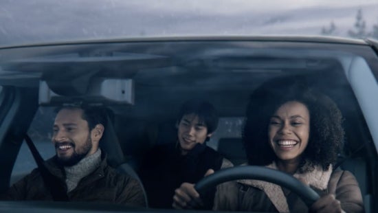 Three passengers riding in a vehicle and smiling | SouthWest Nissan in Weatherford TX
